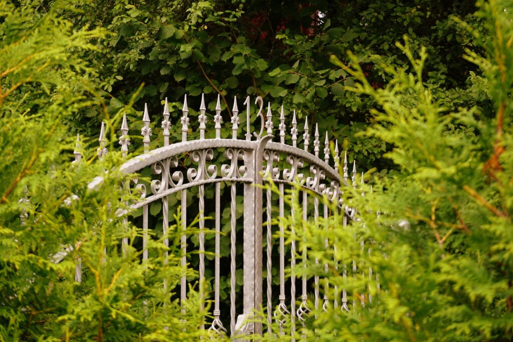 Wrought Iron Gate in shrubs